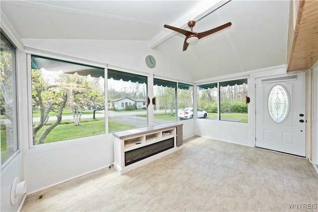 unfurnished sunroom featuring ceiling fan