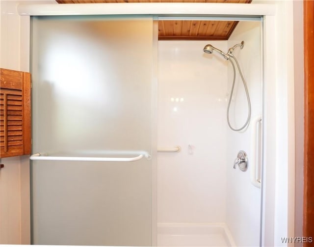 bathroom with a stall shower and wood ceiling