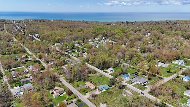 aerial overview of property's location featuring nearby suburban area and a nearby body of water