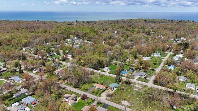 aerial view of property's location with nearby suburban area and a nearby body of water
