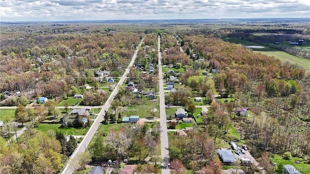 aerial view of property's location featuring a heavily wooded area