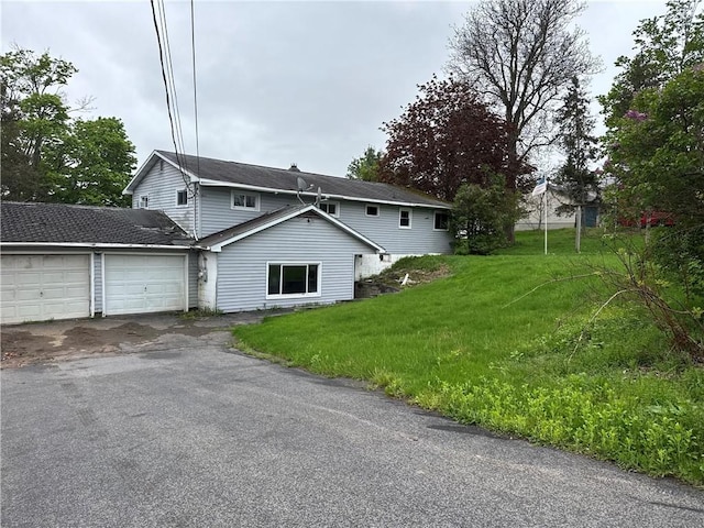 37 Hilltop Dr, Schroeppel, NY 13135 - view of front of home featuring a garage, asphalt driveway, and a front lawn