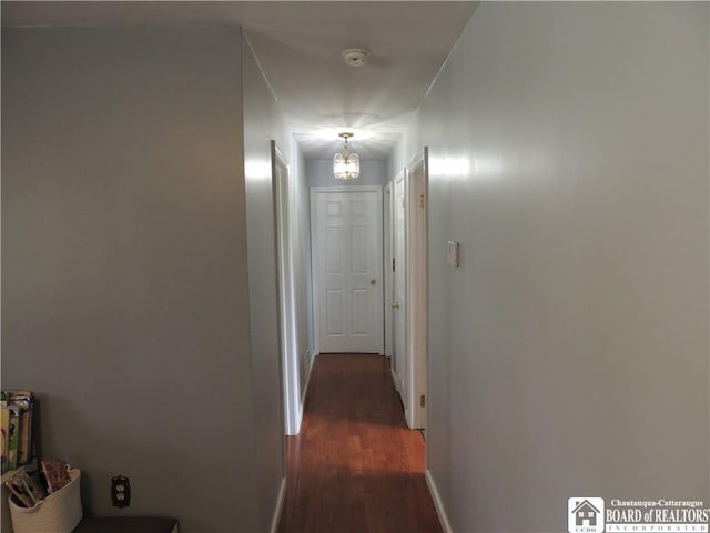 3830 E Ross Mills Rd, Ellicott, NY 14733 - hallway with dark wood-style floors, a chandelier, and baseboards