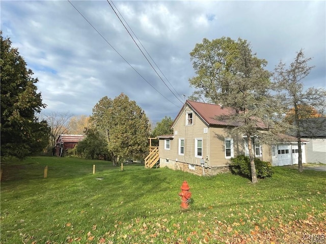 43815 Stine Rd, Alexandria, NY 13679 - view of property exterior featuring a yard and an attached garage