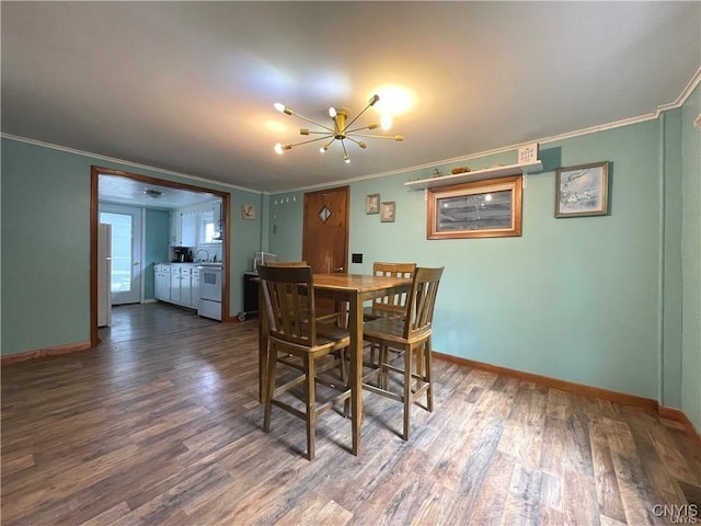 43815 Stine Rd, Alexandria, NY 13679 - dining room featuring crown molding, dark wood-style flooring, a chandelier, and baseboards