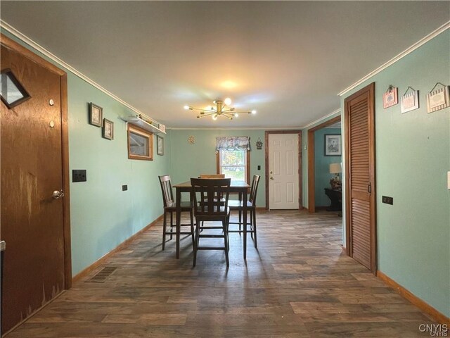 43815 Stine Rd, Alexandria, NY 13679 - dining area with a chandelier, crown molding, dark wood finished floors, and baseboards