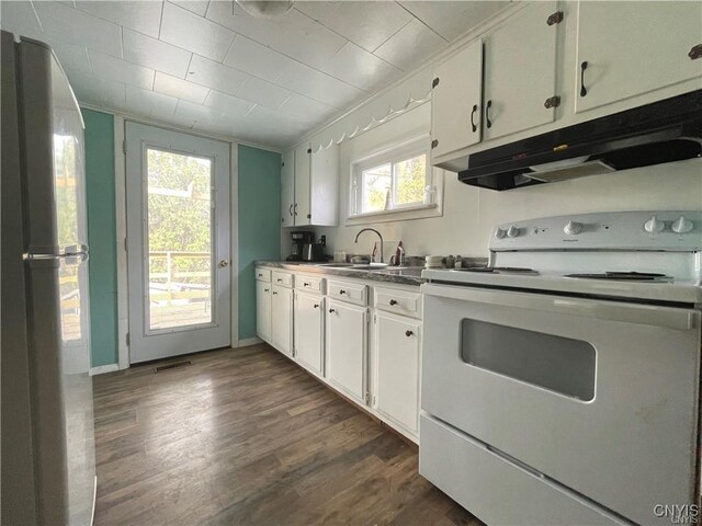 43815 Stine Rd, Alexandria, NY 13679 - kitchen with electric stove, freestanding refrigerator, under cabinet range hood, and white cabinetry