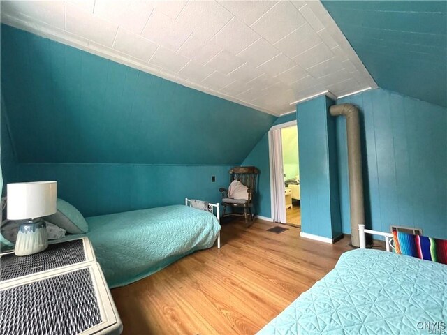 43815 Stine Rd, Alexandria, NY 13679 - bedroom with wood finished floors, lofted ceiling, and baseboards