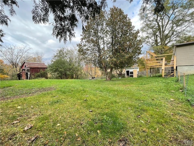 43815 Stine Rd, Alexandria, NY 13679 - view of green lawn with a deck, stairway, an outdoor structure, and a shed