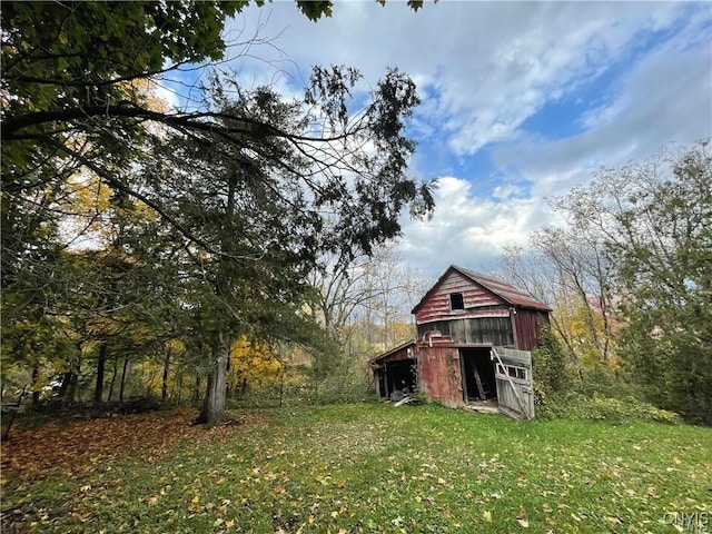 43815 Stine Rd, Alexandria, NY 13679 - view of green lawn featuring a barn and an outbuilding
