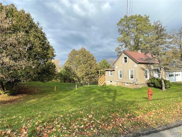43815 Stine Rd, Alexandria, NY 13679 - view of side of home featuring a yard, stairway, and a chimney