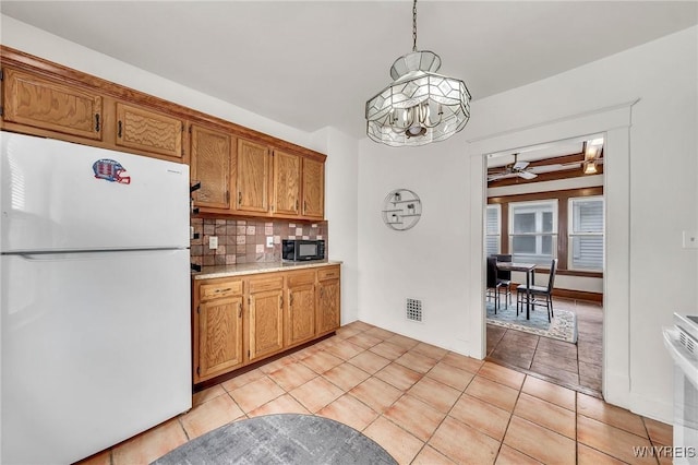 61 Norwalk Ave, Buffalo, NY 14216 - kitchen featuring white appliances, a chandelier, tasteful backsplash, light countertops, and a ceiling fan