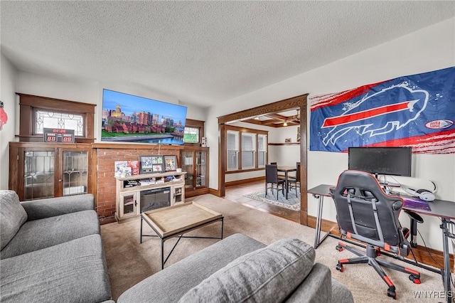 61 Norwalk Ave, Buffalo, NY 14216 - carpeted living room featuring a textured ceiling, healthy amount of natural light, a desk, ceiling fan, and baseboards