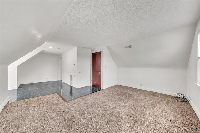 61 Norwalk Ave, Buffalo, NY 14216 - bonus room with dark carpet, vaulted ceiling, a textured ceiling, and baseboards