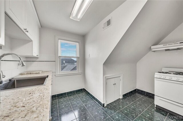 61 Norwalk Ave, Buffalo, NY 14216 - kitchen featuring white gas stove, a sink, white cabinetry, custom exhaust hood, and light countertops