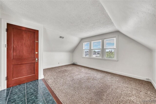 61 Norwalk Ave, Buffalo, NY 14216 - bonus room with dark carpet, vaulted ceiling, baseboards, a textured ceiling, and dark tile patterned flooring
