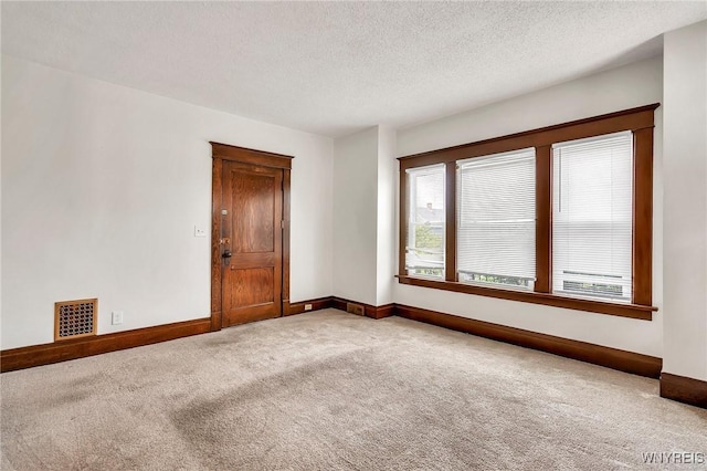 61 Norwalk Ave, Buffalo, NY 14216 - unfurnished room featuring carpet, baseboards, and a textured ceiling