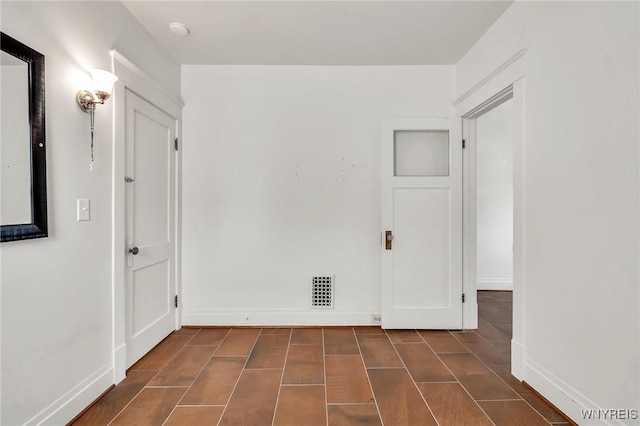 61 Norwalk Ave, Buffalo, NY 14216 - empty room with baseboards, dark tile patterned floors, and a smoke detector