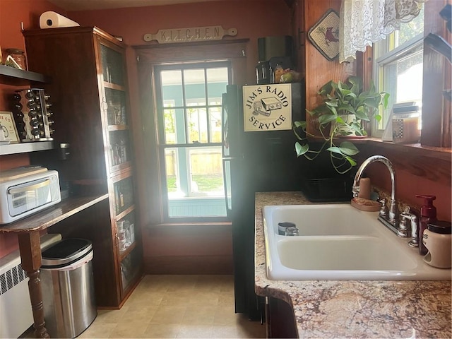 kitchen featuring a sink, plenty of natural light, and light tile patterned floors