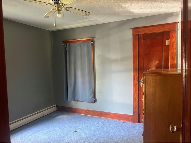 spare room with a baseboard radiator, carpet floors, ceiling fan, baseboards, and a textured ceiling