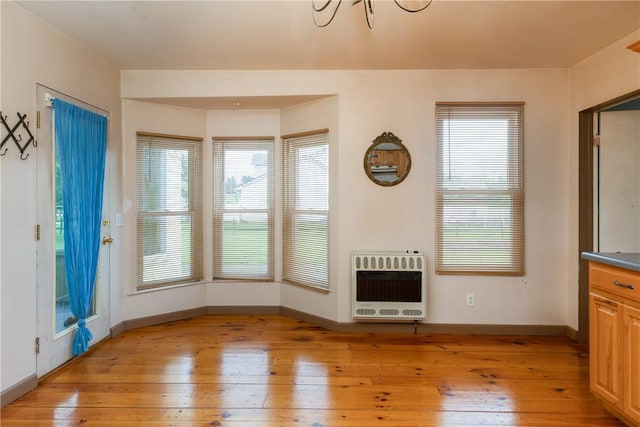 448 Old Ithaca Rd, Horseheads, NY 14845 - unfurnished living room featuring heating unit, light wood finished floors, and baseboards