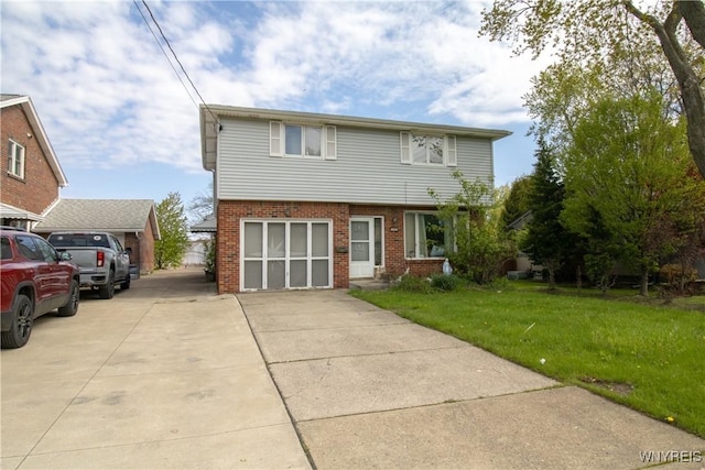 view of front of home with brick siding and a front lawn