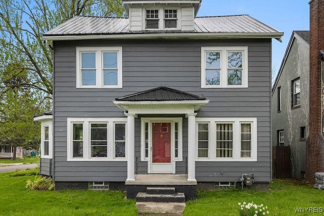 american foursquare style home with metal roof and a front yard