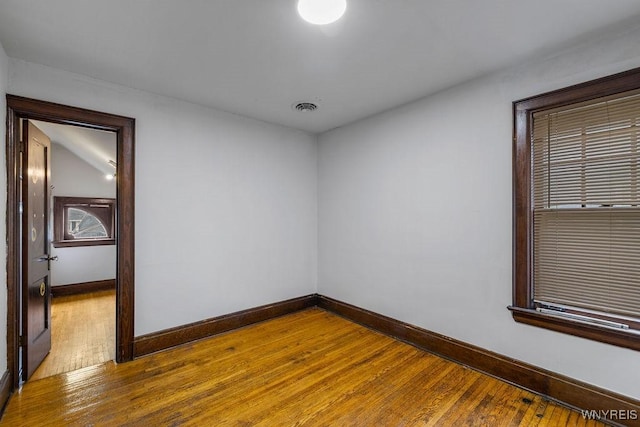 empty room featuring baseboards and wood finished floors