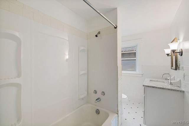 44 Christiana St, North Tonawanda, NY 14120 - bathroom with tile walls, vanity, shower / washtub combination, toilet, and wainscoting