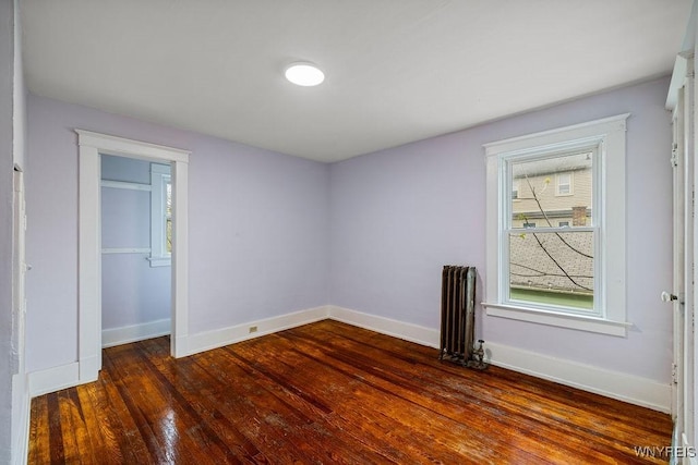 44 Christiana St, North Tonawanda, NY 14120 - unfurnished bedroom with radiator, baseboards, and dark wood-type flooring