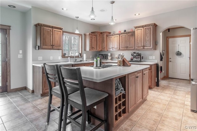 20948 Nys Rte 180, Hounsfield, NY 13634 - kitchen with a sink, light countertops, arched walkways, a kitchen breakfast bar, and a center island