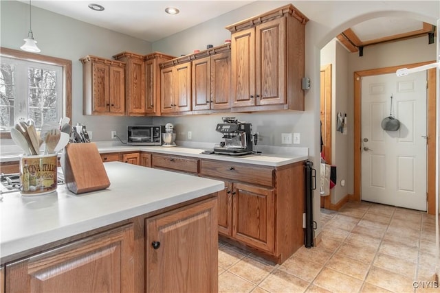 20948 Nys Rte 180, Hounsfield, NY 13634 - kitchen featuring arched walkways, light countertops, light tile patterned flooring, brown cabinets, and recessed lighting