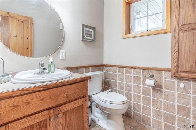 20948 Nys Rte 180, Hounsfield, NY 13634 - half bathroom featuring tile walls, toilet, a wainscoted wall, and vanity