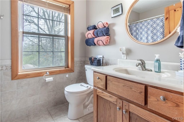 20948 Nys Rte 180, Hounsfield, NY 13634 - full bath featuring tile patterned floors, tile walls, vanity, toilet, and a wainscoted wall