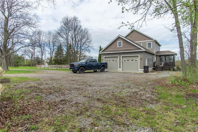 20948 Nys Rte 180, Hounsfield, NY 13634 - view of side of home with fence, an attached garage, and driveway