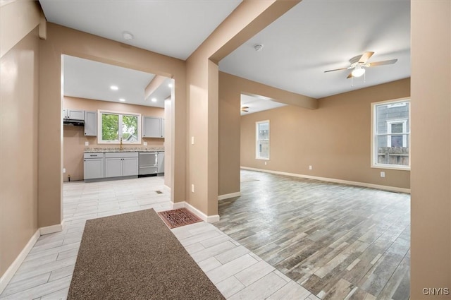 212 N Broad St, Oneida-Inside, NY 13421 - unfurnished living room with ceiling fan, light wood-style flooring, baseboards, recessed lighting, and a sink