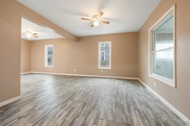212 N Broad St, Oneida-Inside, NY 13421 - empty room featuring a ceiling fan, wood finished floors, baseboards, and healthy amount of natural light