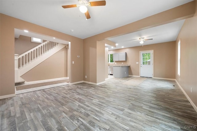 212 N Broad St, Oneida-Inside, NY 13421 - unfurnished living room with ceiling fan, light wood-style floors, baseboards, stairs, and recessed lighting