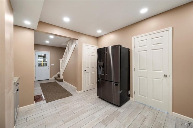 212 N Broad St, Oneida-Inside, NY 13421 - kitchen with black fridge with ice dispenser, baseboards, light wood finished floors, recessed lighting, and light countertops