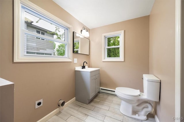212 N Broad St, Oneida-Inside, NY 13421 - bathroom featuring a baseboard radiator, toilet, vanity, and baseboards