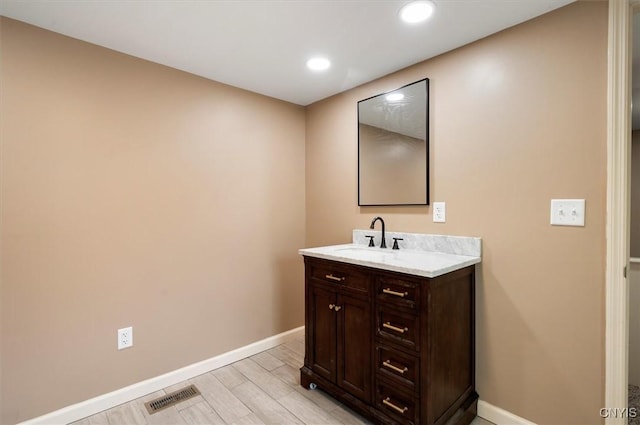 212 N Broad St, Oneida-Inside, NY 13421 - bathroom featuring baseboards, vanity, recessed lighting, and wood finished floors