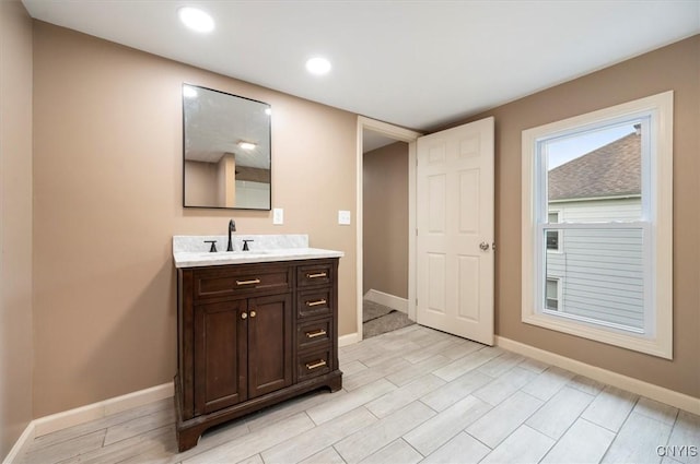 212 N Broad St, Oneida-Inside, NY 13421 - bathroom with baseboards, wood finished floors, vanity, and recessed lighting