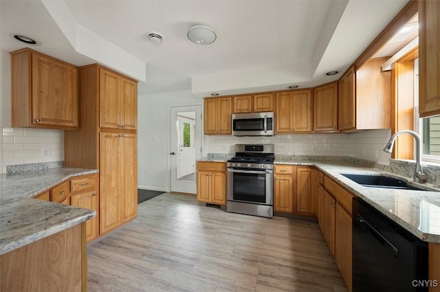 120 Getmac Ave, Lenox, NY 13032 - kitchen featuring appliances with stainless steel finishes, a sink, light stone countertops, and backsplash