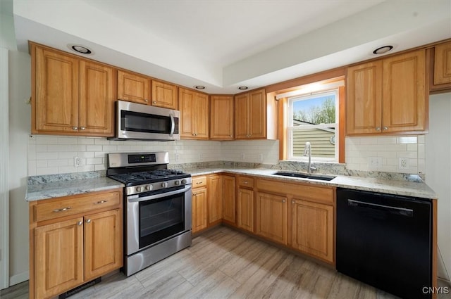 120 Getmac Ave, Lenox, NY 13032 - kitchen with appliances with stainless steel finishes, a sink, decorative backsplash, light stone counters, and light wood-style floors