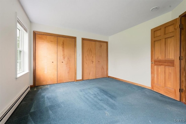 120 Getmac Ave, Lenox, NY 13032 - unfurnished bedroom with a baseboard heating unit, multiple closets, multiple windows, and carpet floors