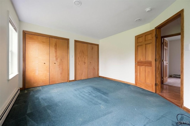120 Getmac Ave, Lenox, NY 13032 - unfurnished bedroom with baseboard heating, two closets, multiple windows, and carpet