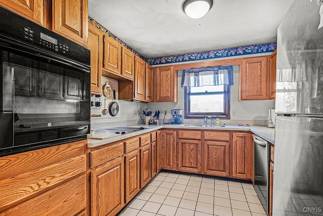 7629 Creek Farm Ln, Trenton, NY 13354 - kitchen with black appliances, light countertops, light tile patterned flooring, brown cabinetry, and a sink