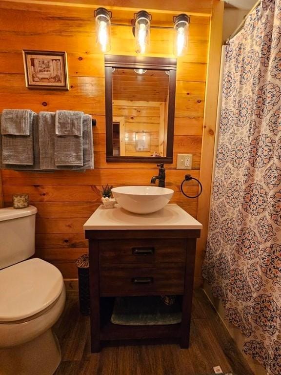 4138 Hubbs Rd, Hector, NY 14818 - bathroom with vanity, wood finished floors, toilet, wooden walls, and a shower with shower curtain