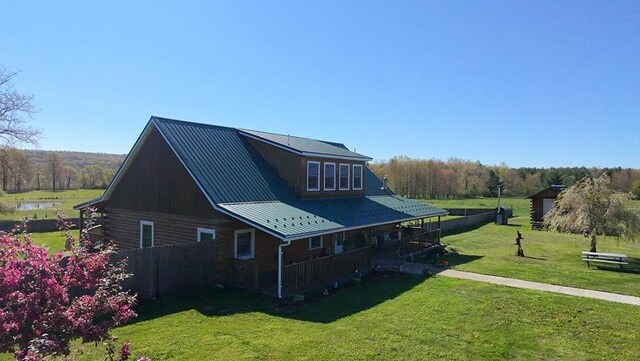 4138 Hubbs Rd, Hector, NY 14818 - view of side of home with a yard and metal roof