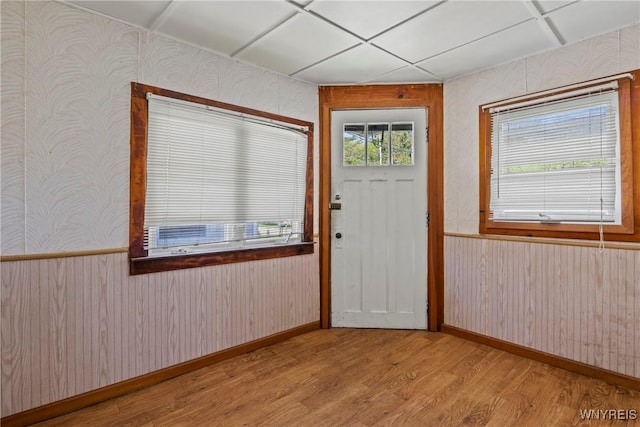 449 Madison Ave, Evans, NY 14006 - foyer entrance with wallpapered walls, light wood-style flooring, a wainscoted wall, baseboards, and wood walls